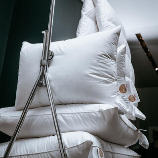 Dundyner og dunputer plassert på en hotelltralle